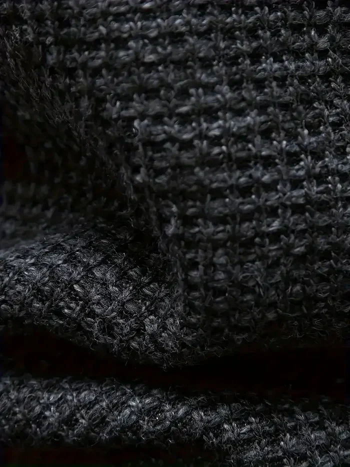 Nahaufnahme von schwarzem Strickstoff mit grober Textur, Wollgewebe Detail