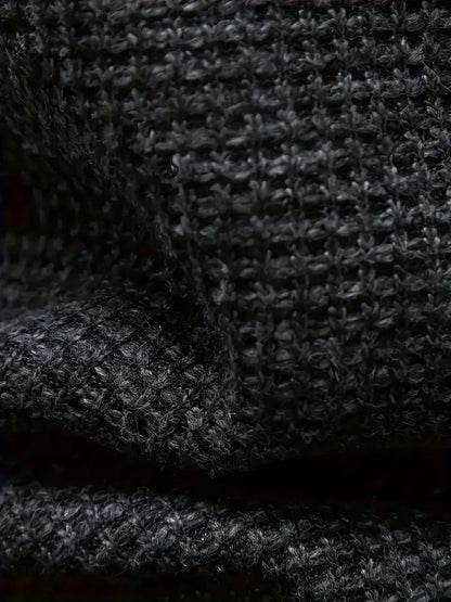 Nahaufnahme von schwarzem Strickstoff mit grober Textur, Wollgewebe Detail